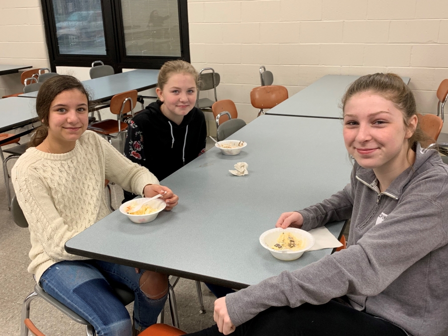 students at tables with bowls of ice cream